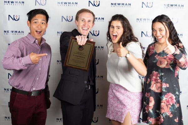 (From left to right) Steven Nguyen, Father Adam Grelinger, Julia Myers and Kelly Mai pose for a photo at the spring Alumni Awards and Beata Benefactors Banquet.