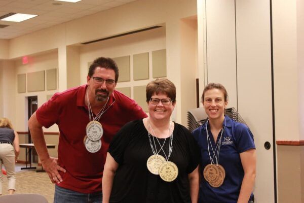 (From left to right) Steve Hamersky, Jeanette Parker, and Melissa Castle at an annual Newman Staff Olympics event.
