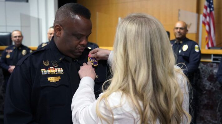 Jill pins her husband, Keith, during a promotional ceremony for the Wichita Police Department (Courtesy photo)