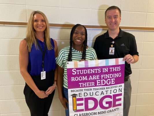 Miquetta White (center) received a grant to help students in the Bryant Opportunity Academy USD 259. (Courtesy photo)