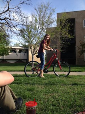 Bass enjoyed riding her bike around the Newman University campus as a student. (Courtesy photo)