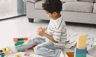 A child plays with toys during a play therapy session