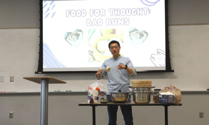 Newman University professor Huachuan Wen shares his bao buns with the Asian Student Association.