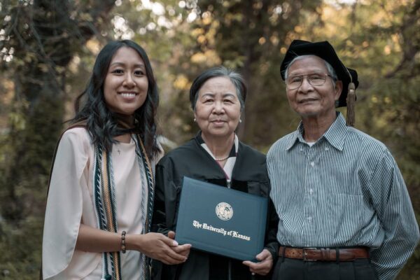 Jenny Nguyen's grandparents wear her graduation gown and hold my PharmD for a photo. (Courtesy photo)