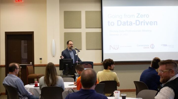 Cochran discusses "Going from Zero to Data-Driven" during a networking event at Newman.