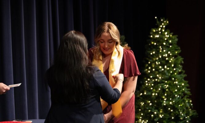 Newman University student earns her nurse pin at the fall 2022 ceremony.