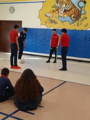 Two middle school soccer players participate in a skill-building activity with Perez and Guereca-Torres. (Courtesy photo)