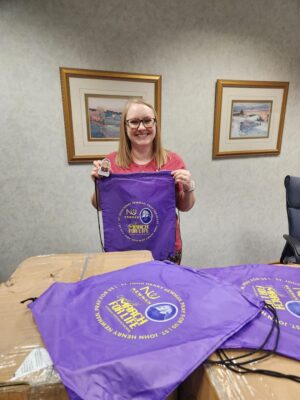 Georgia Drewes, senior associate director of admissions, shows of the 2023 March for Life backpacks in the chancery office of the Catholic Diocese of Wichita, Kansas.