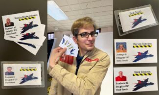 Clark Castle shows off cards from his "Jet Duel" card game at Newman University