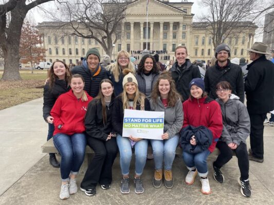 Eleven students and three advisers of Newman University attended the Kansas March for Life Jan. 24 in Topeka. Kaylee McNeil is pictured in the back row, third from the left. (Courtesy photo)