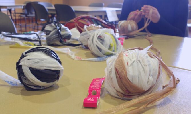 Plastic bags were cut, tied and wrapped up into balls of "plarn," or plastic yarn, for crocheting.