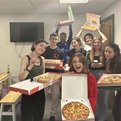 International students got together and ordered pizza.