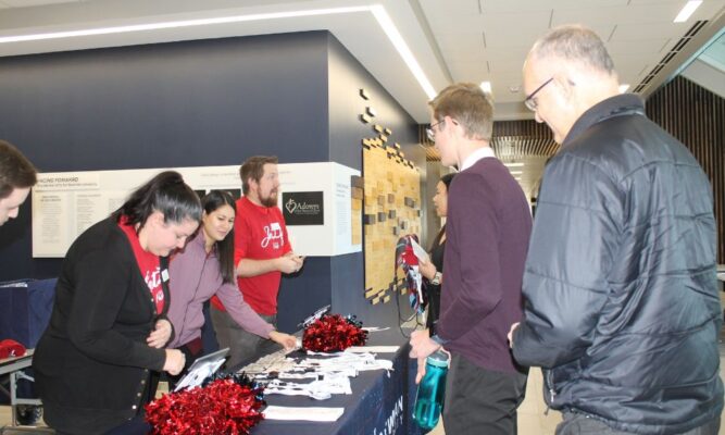 Admissions team members greet students during Scholarship Interview Days at Newman University.