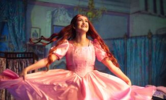 A photo of Ariel twirling in a pic dress in the live Newman performance of 