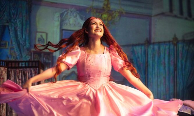 A photo of Ariel twirling in a pic dress in the live Newman performance of "Disney's The Little Mermaid"