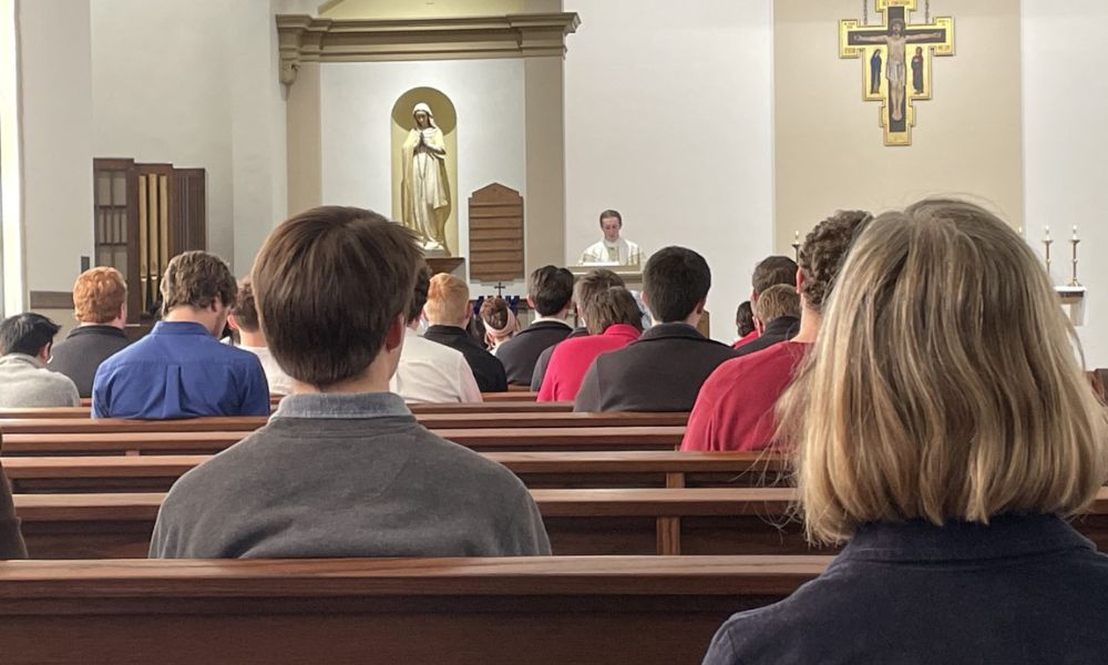 Father Adam Grelinger offers homily during St. Newman Mass Feb. 21.