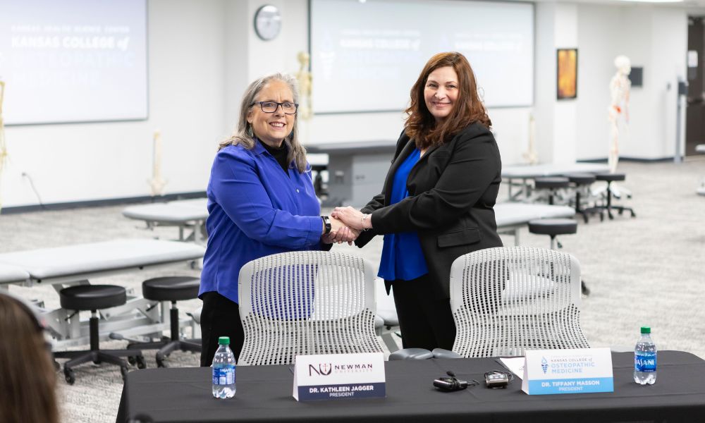 (From left to right) Newman University President Kathleen S. Jagger, Ph.D., MPH, and President of Kansas College of Osteopathic Medicine Tiffany Masson, Psy.D., sign off on the partnership between Newman and KansasCOM March 20.