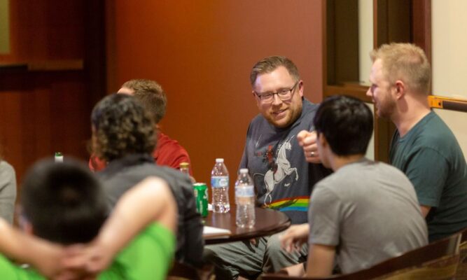 Participants of the Marvel vs. DC Trivia night compete in the Tarcisia Roths ASC Alumni Center.