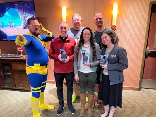 The winning trivia team sports their prizes. (From left to right) Joshua Prilliman, (back row) Kyle Berry and Chris Drewes, (front row) Father Adam Grelinger ‘11, Angie Ayers ‘12 and Assistant Director of Campus Ministry and The Honors Program Emily Simon ‘17. Not pictured: student Tony Ureno.