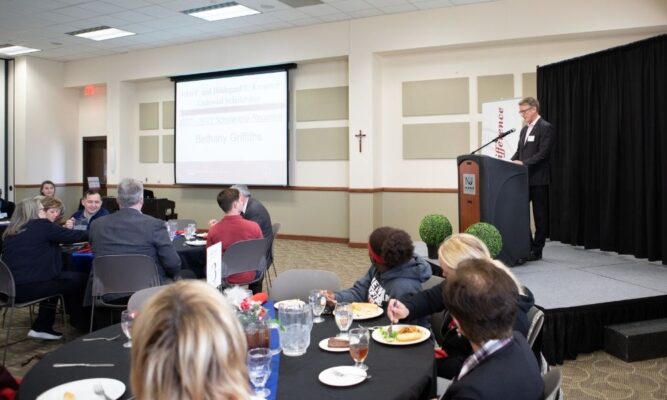 JV Johnston presents his speech to students and donors during the luncheon.