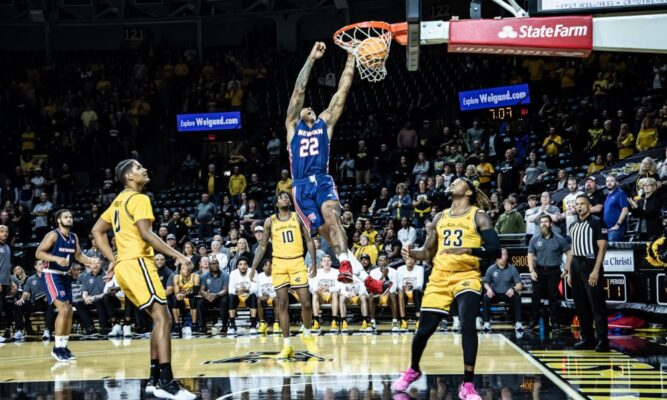 Men's basketball player Khaleem Bennett dunks the ball in a faceoff against Wichita State University. (Courtesy photo Richard Rico)
