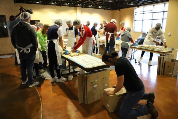 Student, faculty and staff volunteers worked with Numana in the old bookstore space to package bags of rice on March 24.