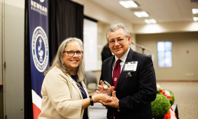 President Kathleen Jagger awards Richard Macías the 2023 Msgr. Leon A. McNeill Achievement Award. 