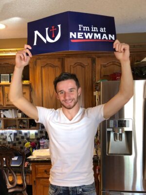 Sanders proudly shows off his acceptance package from Newman University.