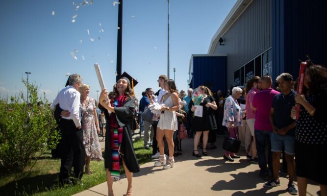 Diaz celebrates with confetti after the Newman commencement ceremony at Hartman Arena.