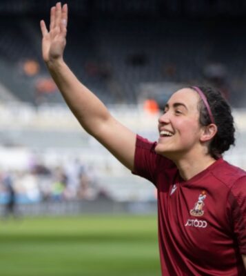 Harriet Jakeman waves to the crowd during a soccer game in the UK. (Courtesy photo)