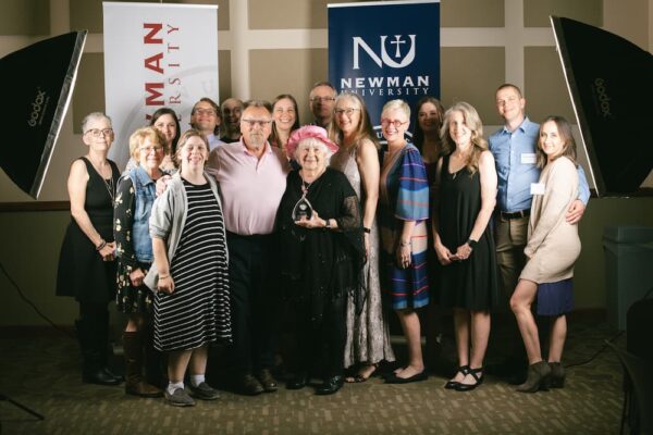 Kelley accepted her Newman alumni award surrounded by all six of her children and family.