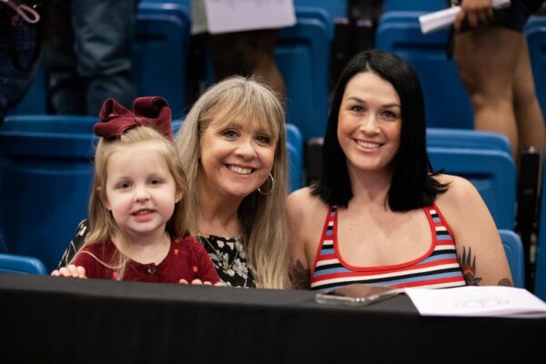 Christy smiles with family members in Hartman Arena during Newman commencement May 12.