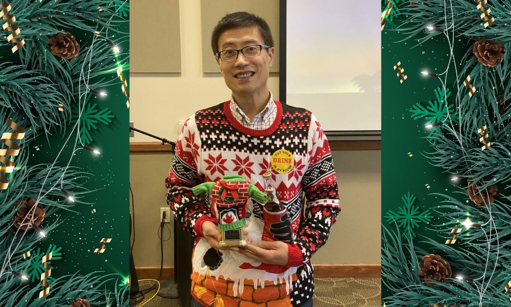 Huachuan Wen wears a Christmas sweater during the 2022 Holiday Party.