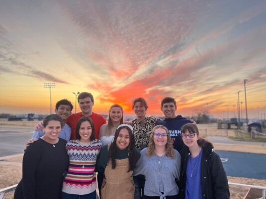 Members of Metanoia pose for a photo at sunset.