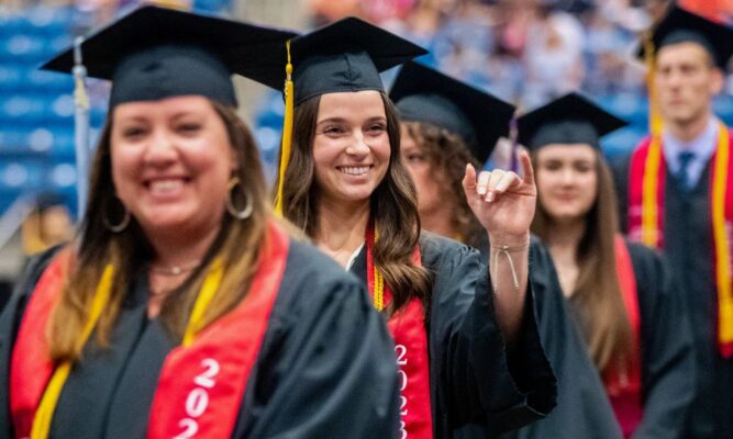Caroline Williams '23 waves to family members during commencement.