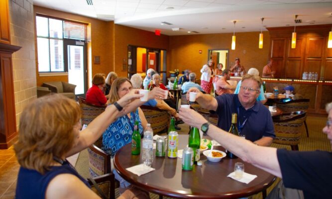 Alumni say "cheers" during a social hour/ mixer in the Tarcisia Roths, ASC, Alumni Center.