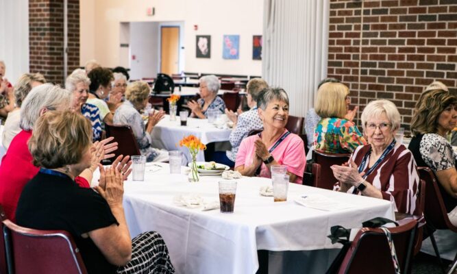 Graduates of Sacred Heart Academy attend a luncheon in the Mabee Dining Center.