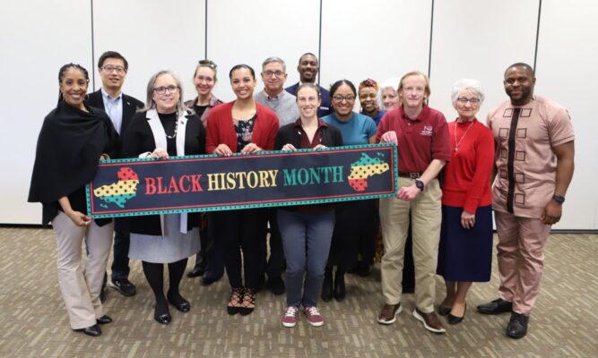 Folefac (far right) stands with Newman staff and faculty during the Martin Luther King Jr. Distinguished Service Awards event.