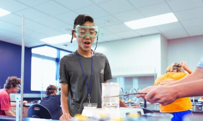 A student of the 2023 ISSP camp reacts to an exciting lab experiment.