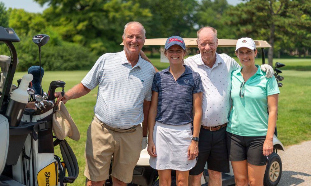 Guests of the 38th annual Jet Open charity golf tournament smile.