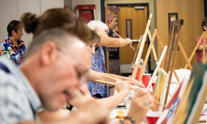 Alumni let their creativity flow during an event in the art room.