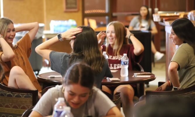 Students dance from their seats during a game of Singo Bingo.