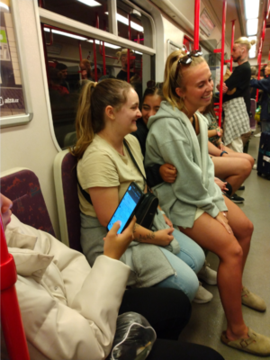 a full subway with girls laughing