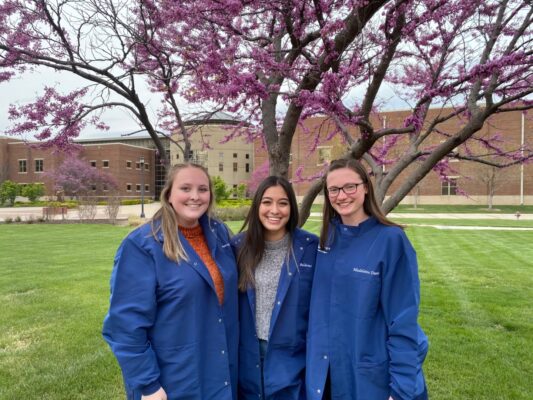(Left) Averie Ashley stands on campus with fellow Newman science program graduates. (Courtesy photo)