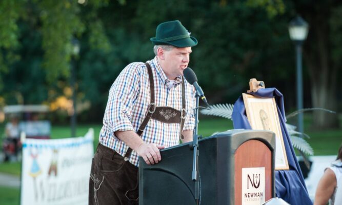 J.T. Klaus, Master of Ceremonies, sports lederhosen during an Oktoberfest-themed Party on the Plaza event in 2015.