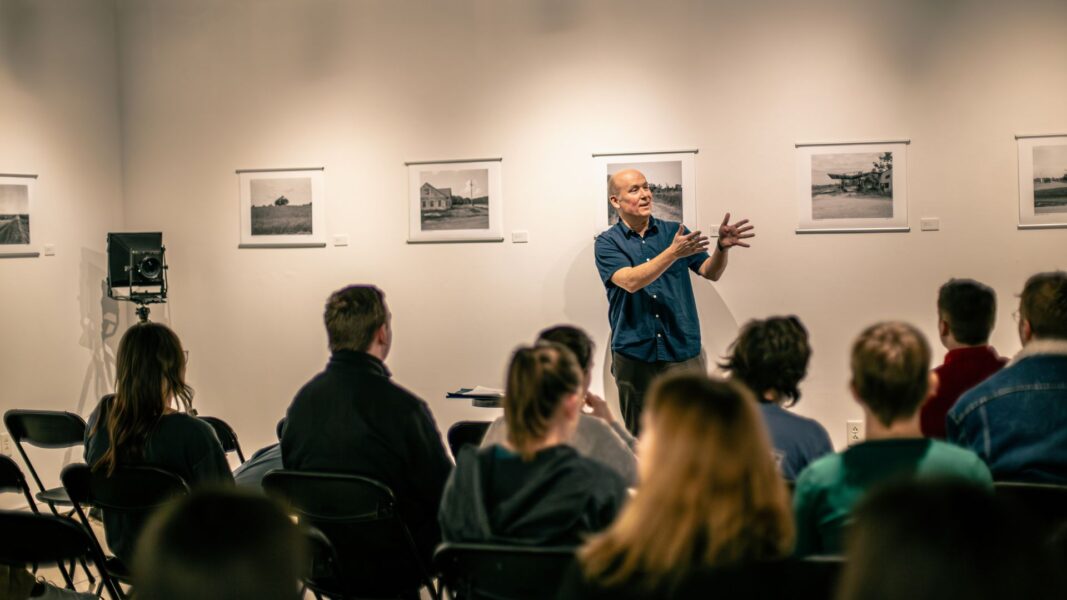 Photographer and featured artist Cary Conover presents for students during "Art for Lunch" in the Steckline Gallery.