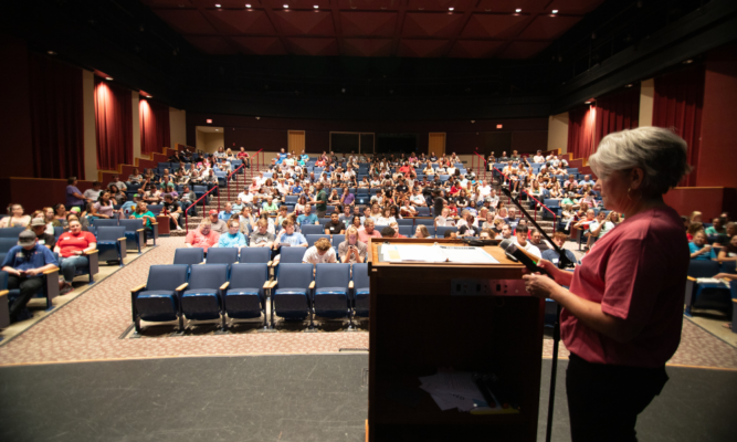Dean of Students Andi Giesen prepares to address new students and families in the DeMattias Performance Hall during orientation day Aug. 19.