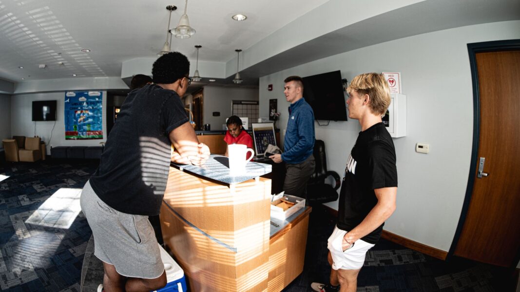 Director of Residence Life Ian Lecki interacts with students and residence assistants in Carrocci Hall.