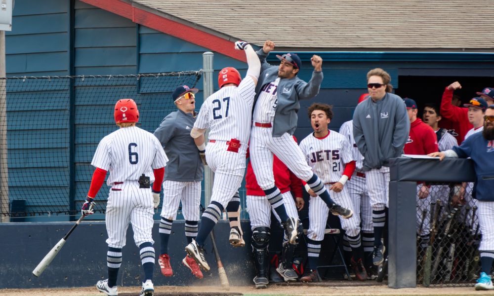 The Newman Univeristy Jets baseball team celebrates after a win.