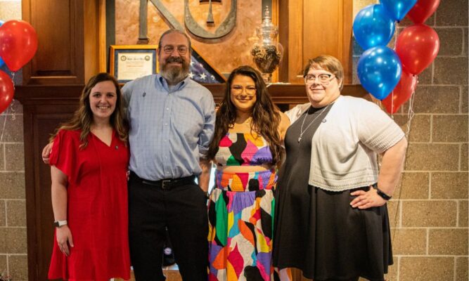 Winters (second from left) and fellow social work graduates at the Master of Social Work pinning ceremony in May 2023.